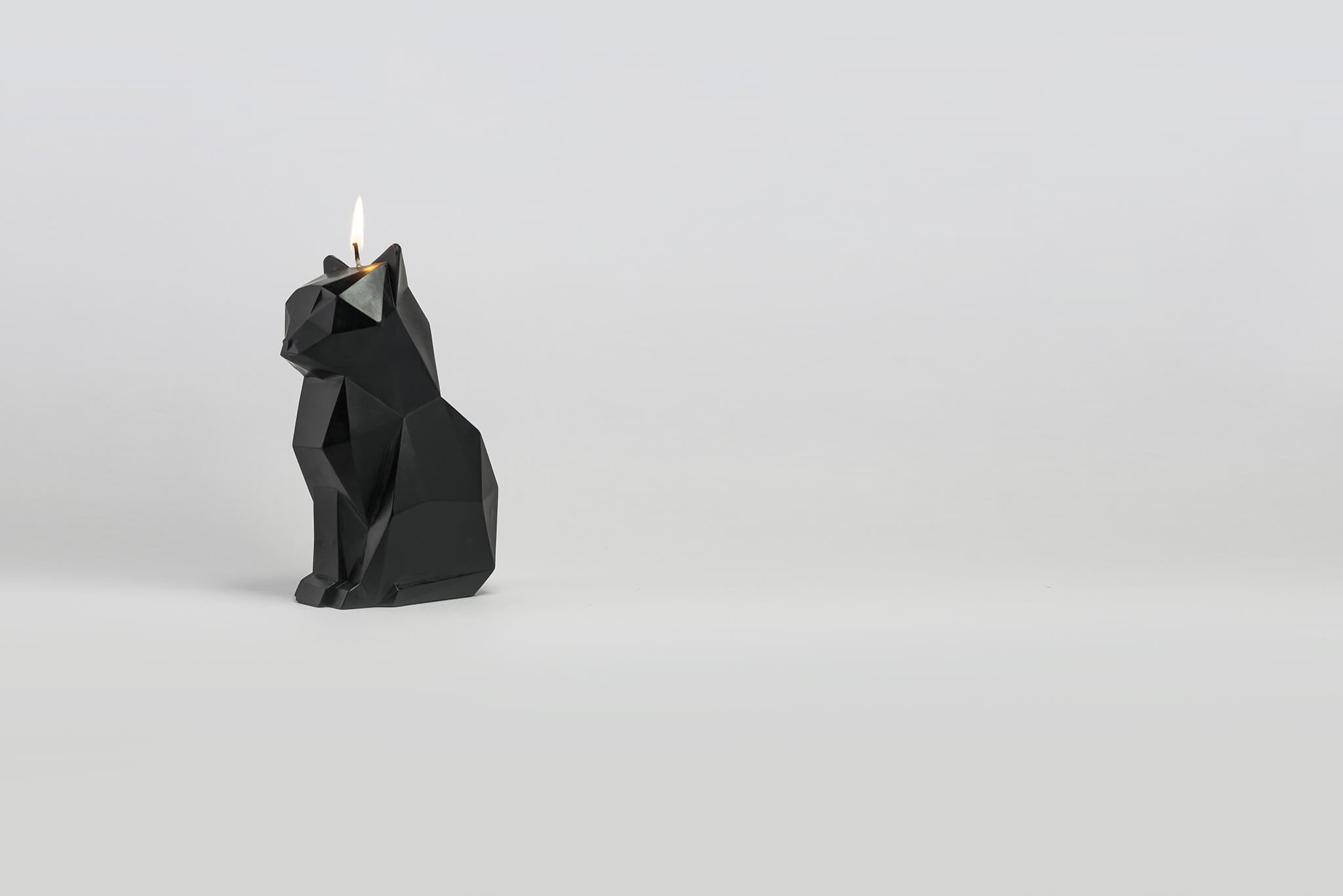 Side view of burning black kisa the cat pyropet candle. The perfect cat gift for cat lovers. 